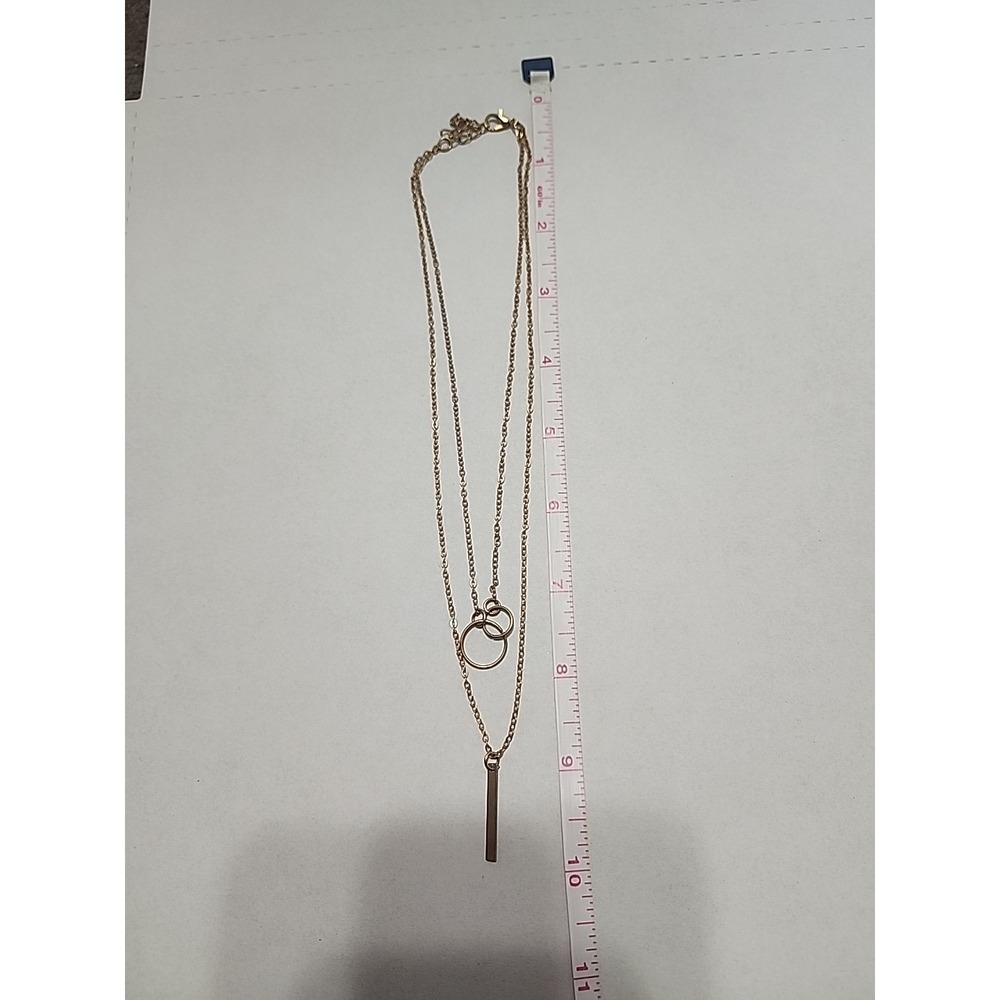 Minimalist Double-chain necklace featuring interlocking circles and Bar.‎